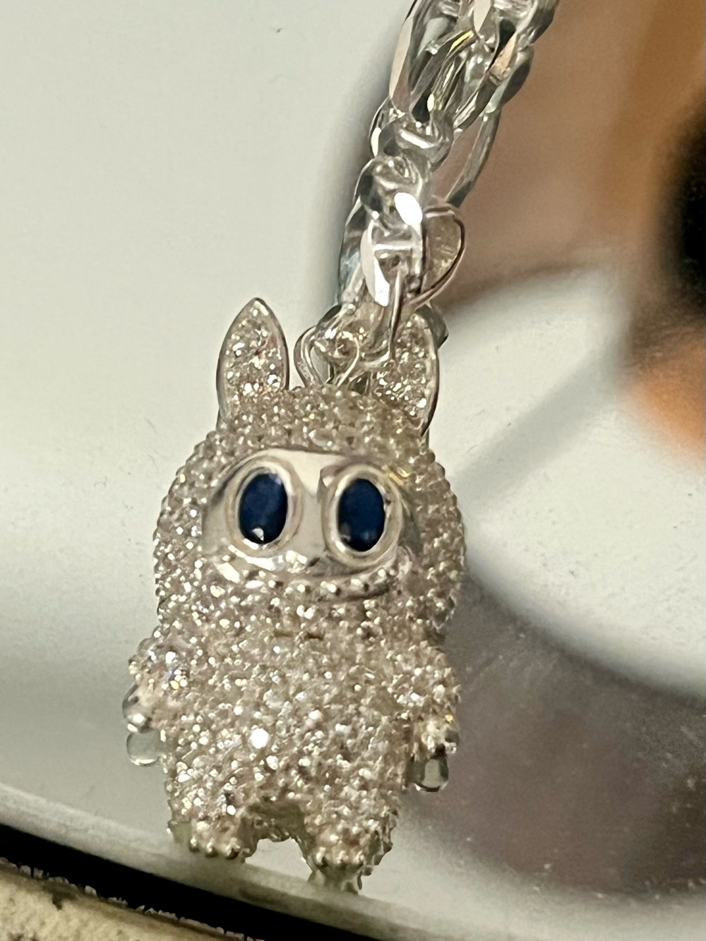Silver toned necklace with Labubu pendant.